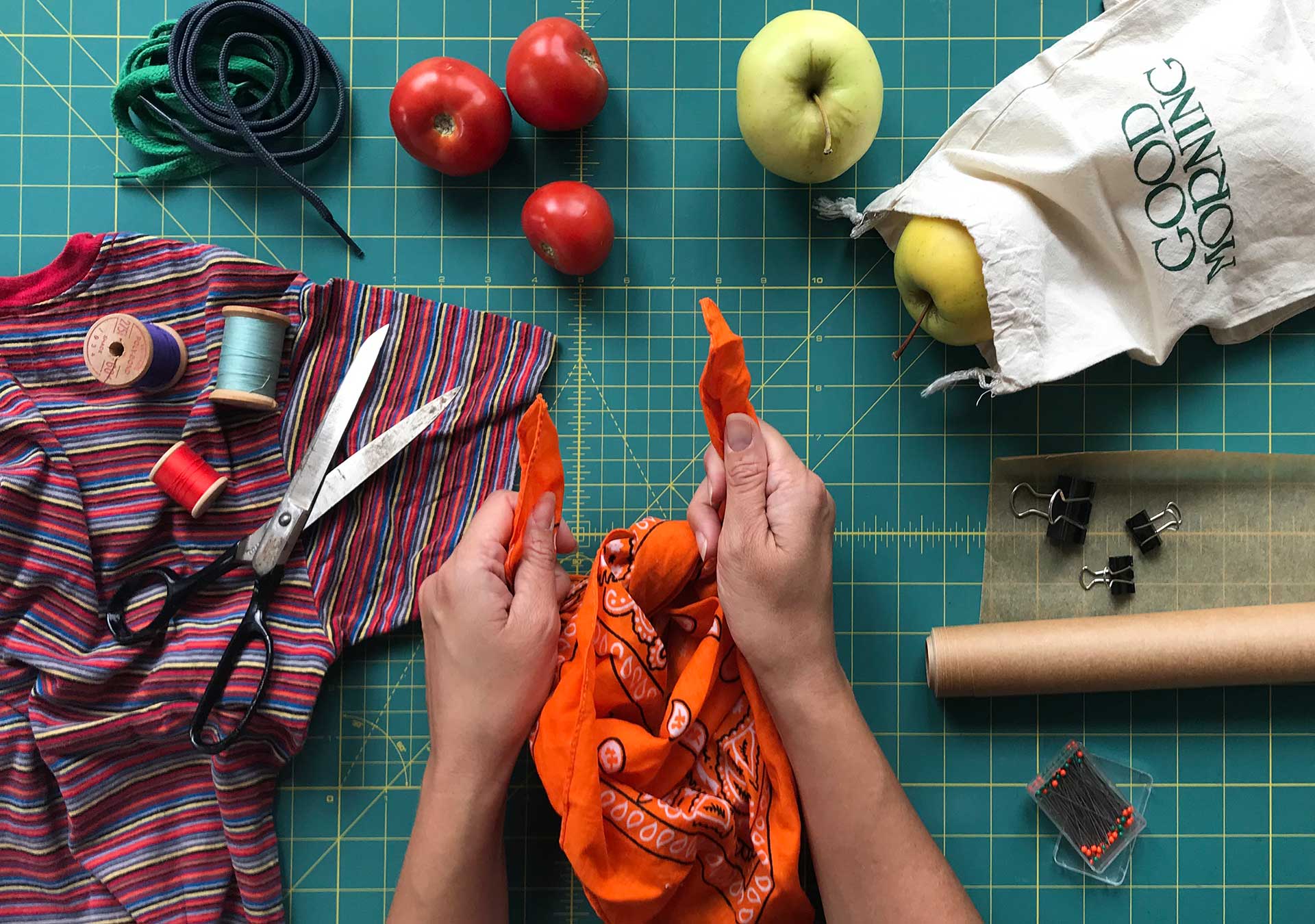 hands working at craft table making reusable produce bag with handkerchief