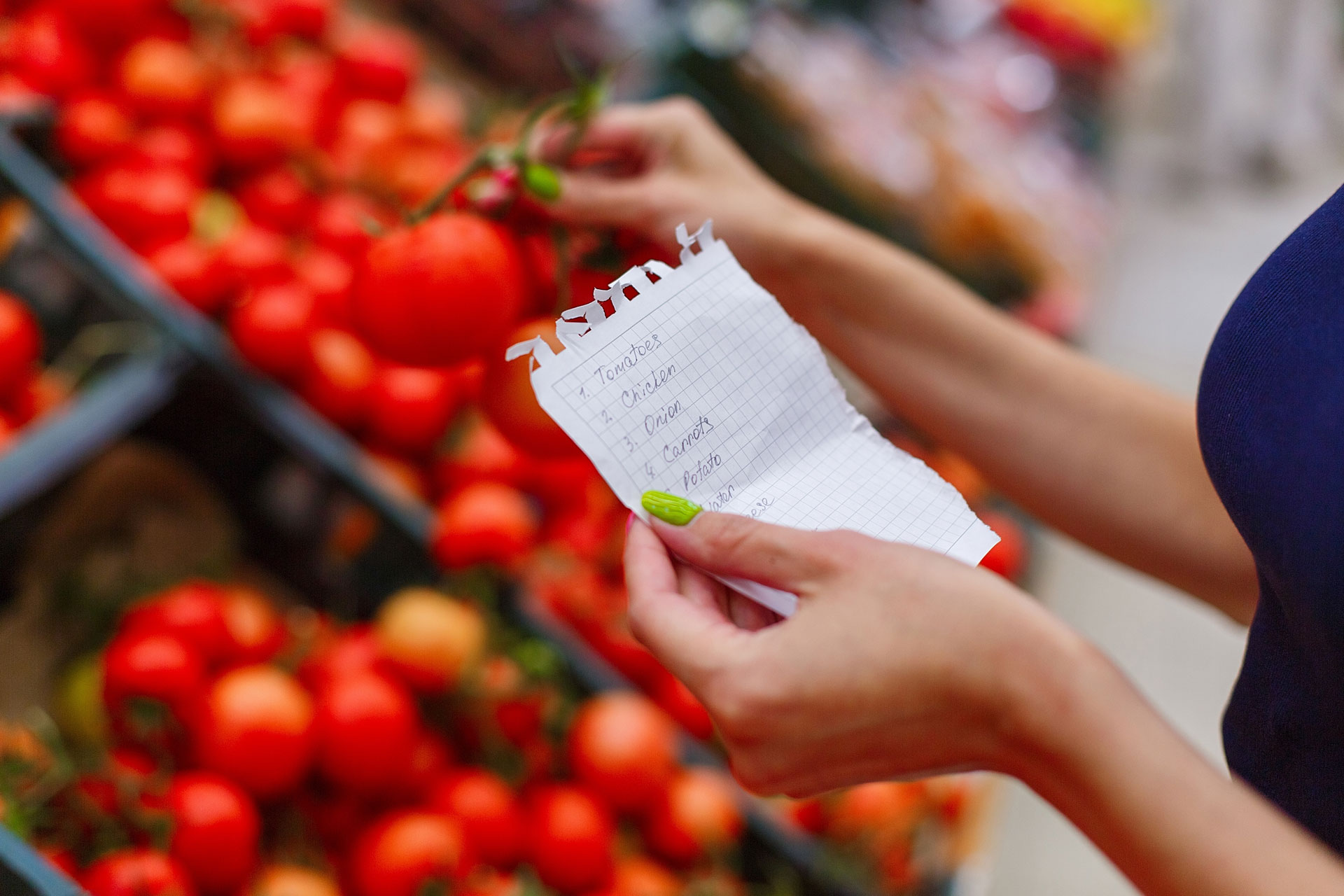 person shopping with grocery list